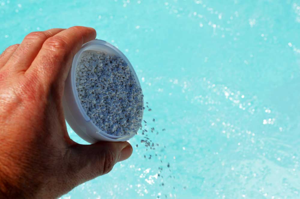 chemicals being poured into a hot tub