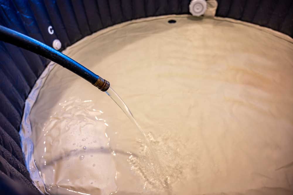 hose filling a hot tub with water