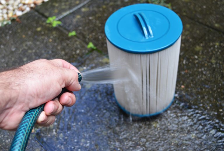 cleaning a filter with a hose