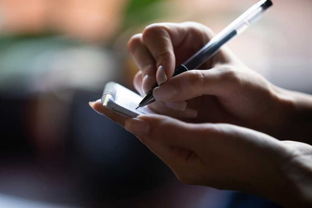 a person writing a list