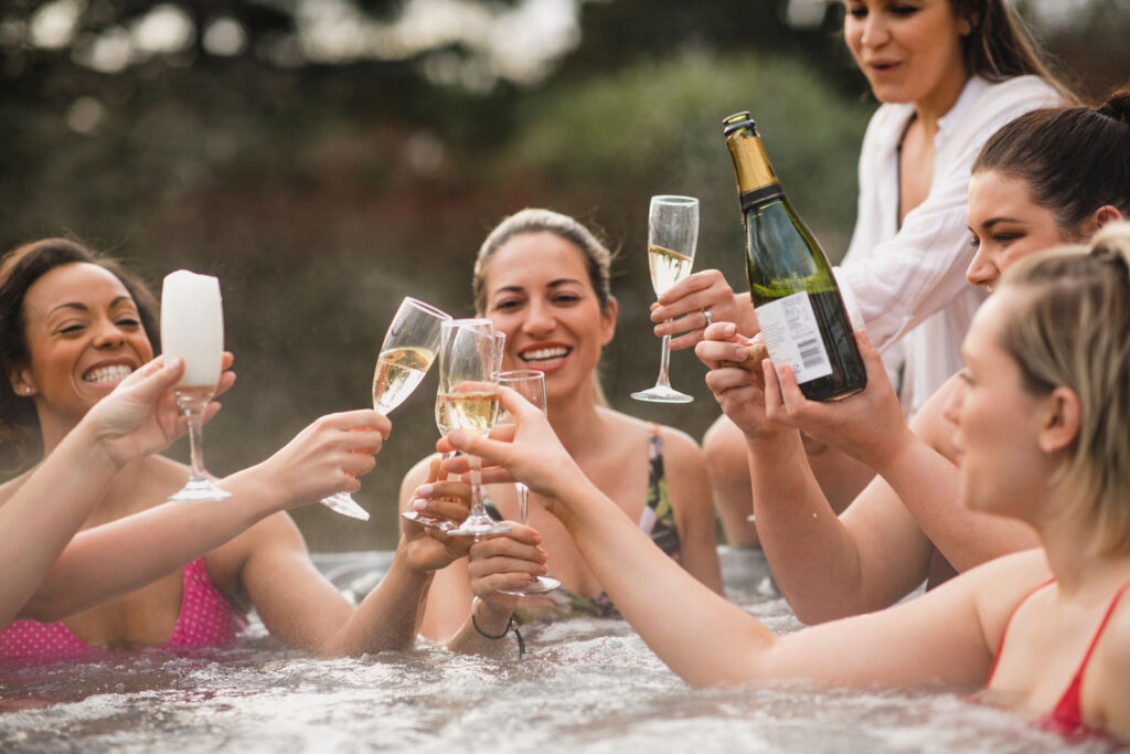 friends drinking in a hot tub