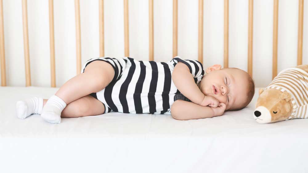 baby sleeping in a cot