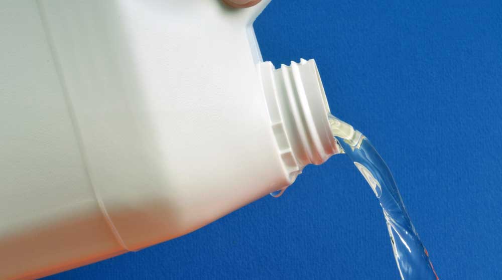 container with liquid being poured