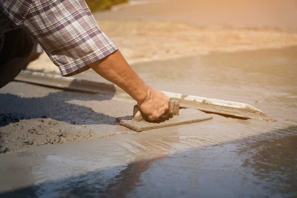 someone smoothing over concrete