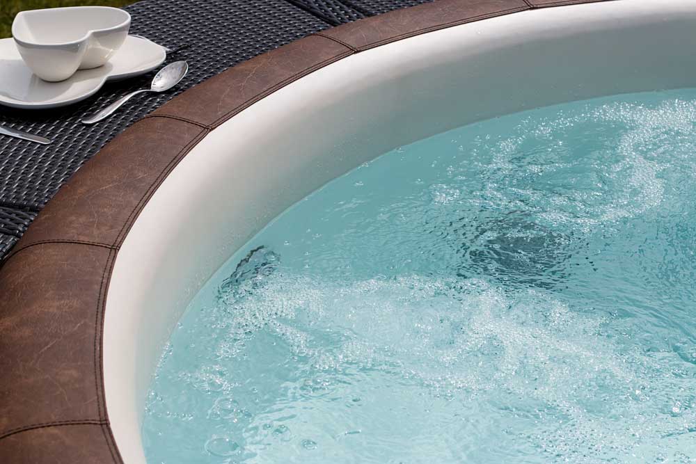 a hot tub with heart shaped bowl next to it