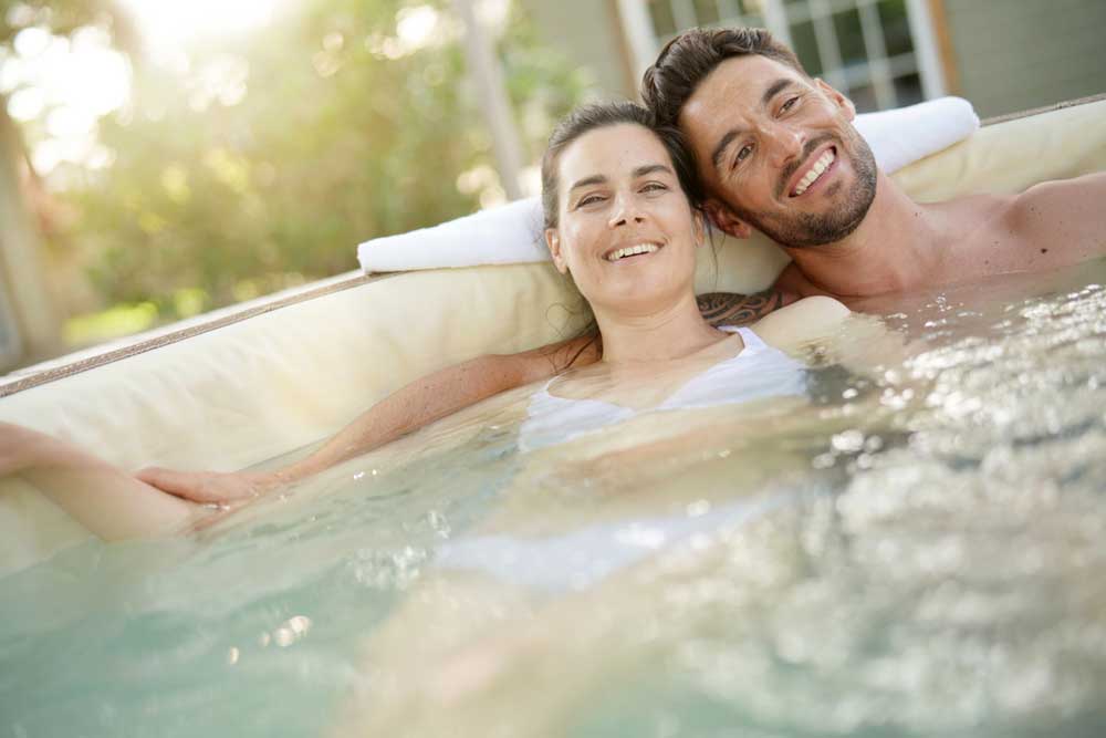 couple sat in a hot tub cuddling