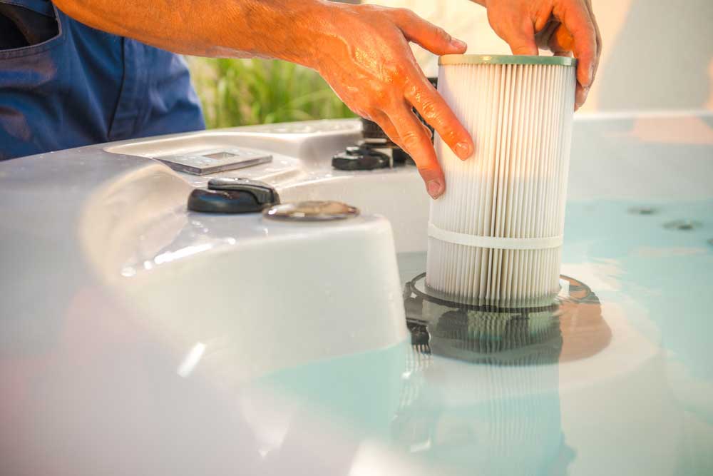 someone putting there filter back in there hot tub