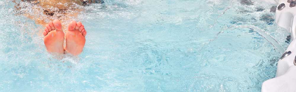 a set of feet in a hot tub