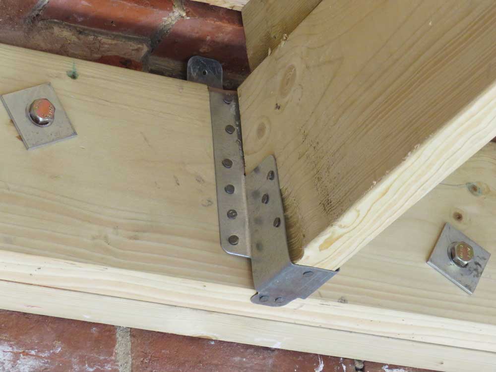 two planks of wood being reinforced