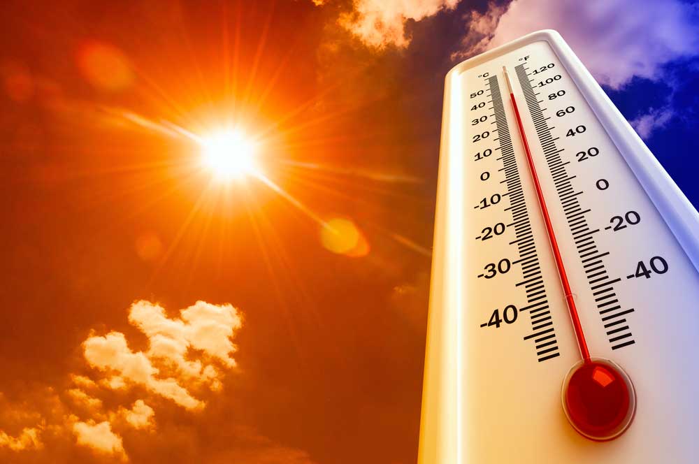 an image of a thermometer and the sun in the background