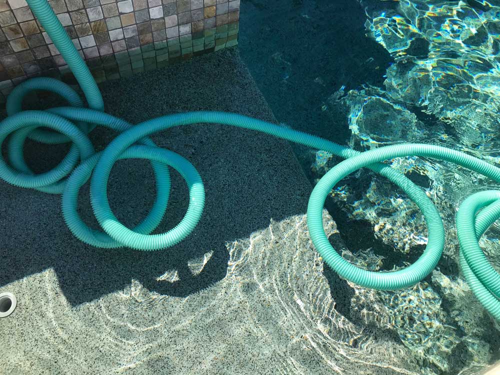 green tubing floating on the surface of the water